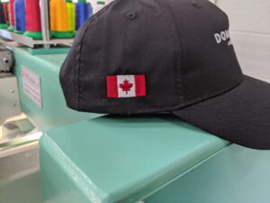 Custom printed T-shirts with multi-location branding and embroidered hats for a large corporate client by Toucan Promotions